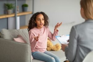 Successful therapy. Teen patient talking to psychologist at her office, expressing emotions